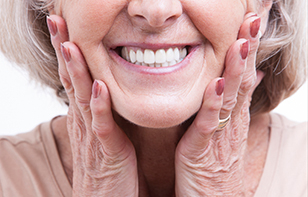 Senior woman showing her dentures with a smile