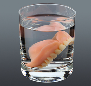 Dentures Soaked in a Glass of Water