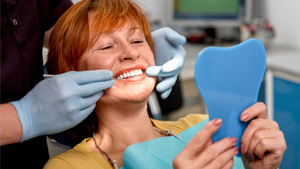 Dentist shows a female patient her teeth