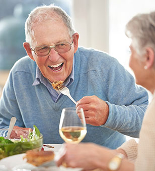 Senior eating with dentures